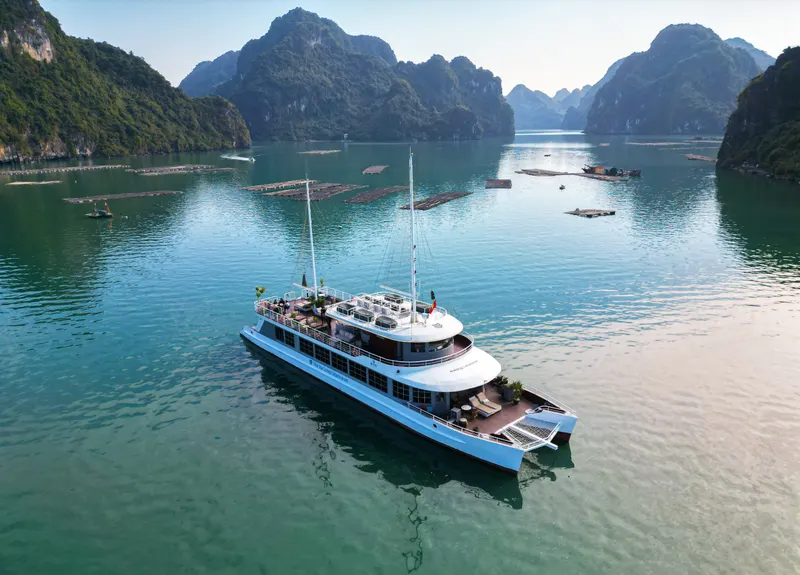 A boat crossing calm water between islands