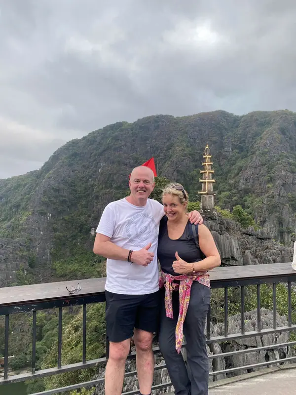 Two guests smiling at the Mua Cave viewpoint